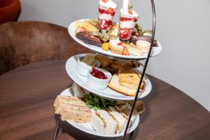 a three tiered plate of food on a table at Park House Hotel in Shifnal