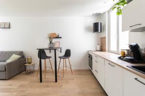 a kitchen with a table and chairs in a room at Chez Lucas in Dinan