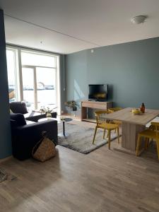a living room with a couch and a table at Svolvær Havn Apartments in Svolvær +25 photos