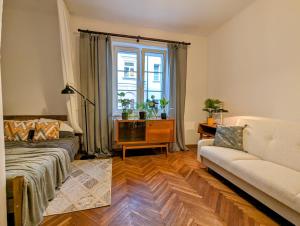 a living room with a couch and a window at APARTAMENT VINTAGE parter in Płock