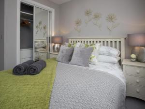 a bedroom with a bed with pillows on it at Portland View in Bristol