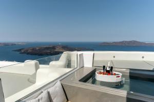 a table on a boat with a bowl of fruit at Kafieris View in Firostefani