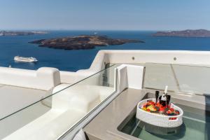 a table with a basket of wine bottles on a yacht at Kafieris View in Firostefani