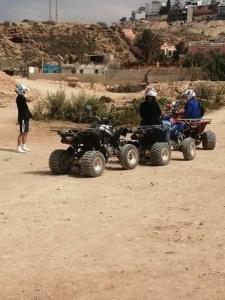 a group of people riding atvs in the dirt at Agadir aourir maroc in Aourir