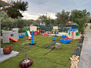 a childrens playground with play equipment in a yard at Sunshine Apartments in Makri