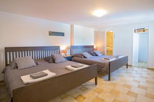 a bedroom with two beds with towels on them at Villa Colombes in Draguignan +40 photos