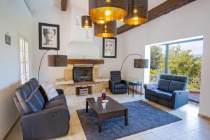 a living room with two chairs and a fireplace at Villa Colombes in Draguignan