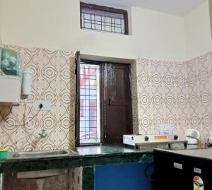 a kitchen with a sink and a window in it at Shiva Homestay in Rishīkesh +12 photos