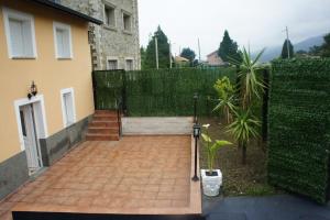 a brick walkway in front of a house with a fence at CASA CADAVEDO (LUARCA) ASTURIAS in Villademoros