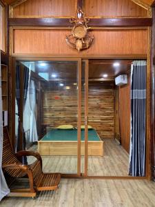 Tân Tạo的住宿－Đan Khôi Homestay Lagi，卧室配有玻璃墙内的床铺