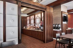 a bar in a restaurant with a table and chairs at Fairfield Inn & Suites by Marriott Washington Downtown in Washington