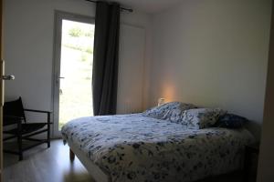 - une chambre avec un lit et une grande fenêtre dans l'établissement Maison Cluny, à Cluny