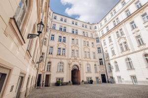a large building with a door in a courtyard at Magnificent historical penthouse in the heart of Prague in Prague