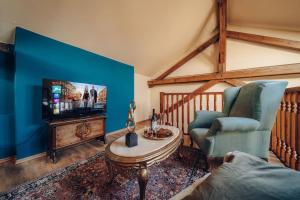 a living room with a couch and a tv at Magnificent historical penthouse in the heart of Prague in Prague