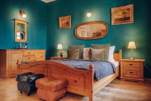 a bedroom with a large wooden bed with a mirror at Magnificent historical penthouse in the heart of Prague in Prague