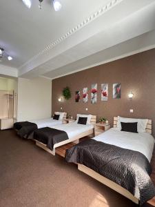 A bed or beds in a room at Caravan Hotel