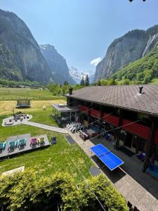 a view of a building with mountains in the background at Alpine Base Hostel - Adults only in Lauterbrunnen