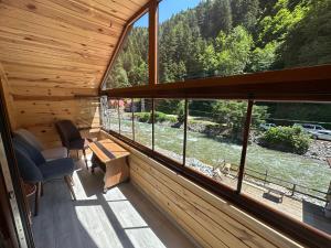 a room with a large window in a log cabin at Haros Suite Hotel in Uzungol