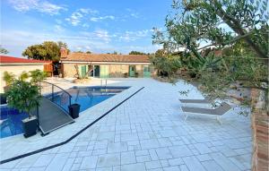 a backyard with a swimming pool and a house at Amazing Home In Nerezine With Outdoor Swimming Pool in Nerezine