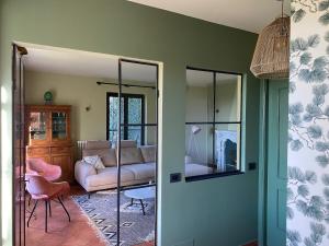 a living room with a couch and a mirror at Villa Monte Rosa al Golfo by PortofinoVacanze in Rapallo