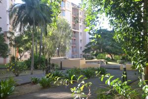 a courtyard in a building with trees and plants at RESIDENCE CYBERVILLAGE THREE ROOMS Apartment in Ebene