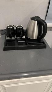a black counter top with a tea kettle on it at dana hotel apartments in Taif