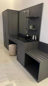 a kitchen with a black counter and a stool at dana hotel apartments in Taif