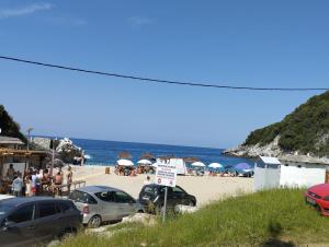 a beach with a lot of cars parked on it at Dimosthenis Karastamatis Rooms in Xorychti