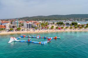 a group of people in the water at a beach at Apartment Sunny Terrace in Bibinje
