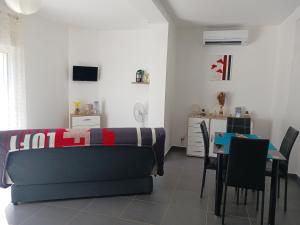 a living room with a couch and a table at location vacances in Linguizzetta