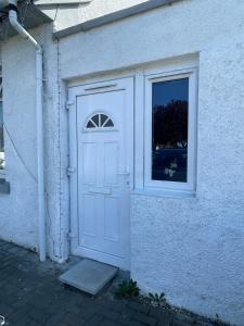 a white door and a window on a building at One Bedroom Self Catered Serviced Accommodation 10 Minutes from City Center in Edinburgh