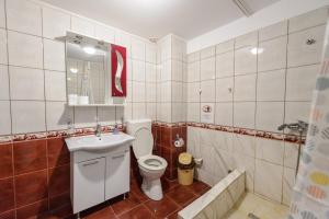 a bathroom with a toilet and a sink at Vila Blue Eforie Nord in Eforie Nord +66 photos