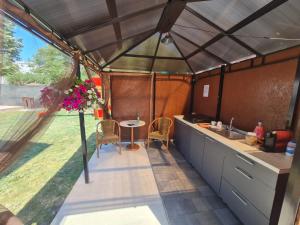 a kitchen and dining area of a camping tent at Vila SIA Eforie Sud in Eforie Sud
