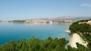 a large body of water with a beach and a city at Madunić in Podstrana