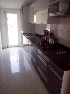 a kitchen with a sink and a stove top oven at Madunić in Podstrana