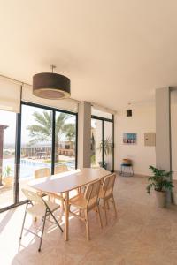 a dining room with a table and chairs at Little Venice Chalet- Private Villa- Dead Sea Jordan in Sowayma