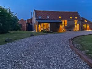 a house with a gravel driveway in front of it at The Roost - Uk42856 in Rise
