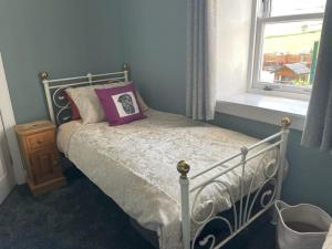 坎貝爾敦的住宿－Southend, Mull of Kintyre, Campbeltown，一间卧室配有一张带枕头和窗户的床