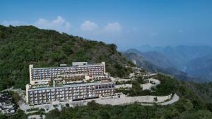 a hotel on top of a mountain with a river at The Westin Resort & Spa Himalayas in Rishīkesh