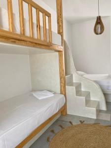 a room with a bunk bed and a staircase at Fikas Hotel in Naxos Chora
