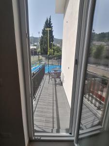 a balcony with a view of a swimming pool at B&B Villa Agrumé in Messina