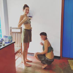 a woman standing next to a girl in a room at Eastwind Surf Camp in Arugam Bay