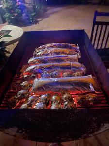 a row of ribs cooking on a grill at Eastwind Surf Camp in Arugam Bay