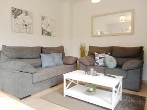 a living room with a couch and a table at La Casa de Marina in Viveiro