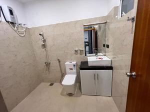 a bathroom with a toilet and a sink at Luxury 2BR Apartment in Ratmalana in Ratmalana South