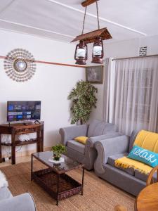 a living room with a couch and a table at Elegant Touch Home - 2 Bedroom House in Karen in Nairobi
