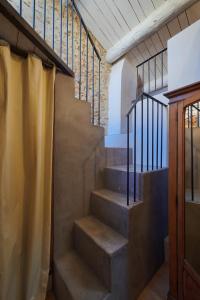 a staircase in a house with metal railing at Les Sardines aux Yeux Bleus Chambres d'Hôtes in Aigaliers