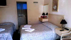 Ένα ή περισσότερα κρεβάτια σε δωμάτιο στο Forster Beach Motel