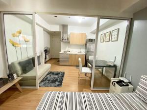 a small apartment with a living room and a kitchen at Azure Staycation Magical Suite in Manila