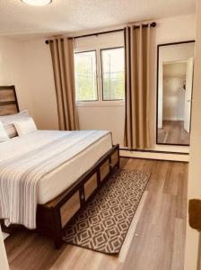 a bedroom with a bed and a large window at North Star Place Apt 12 (premium) in Fairbanks